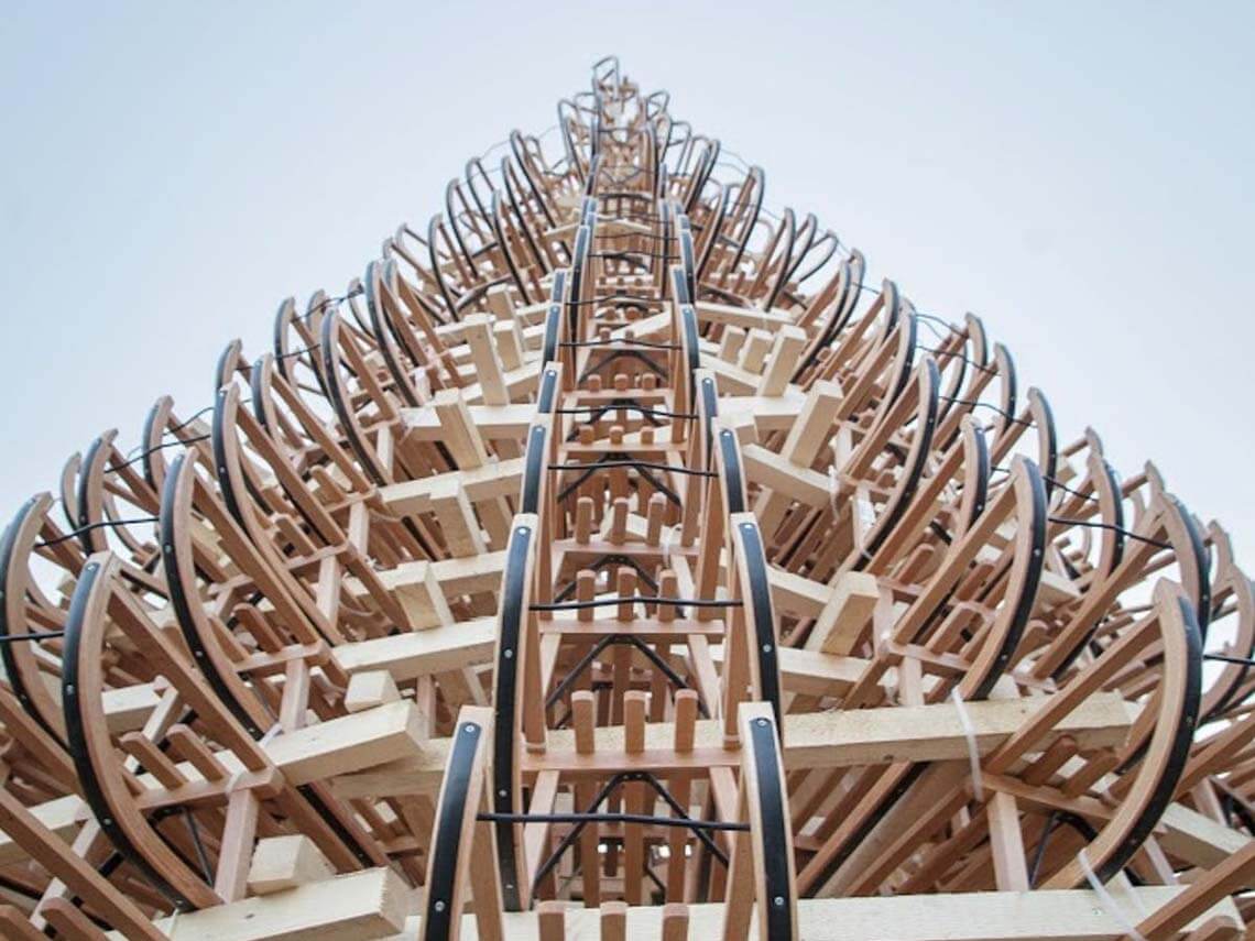 A public art christmas tree in budapest made out of wooden sleighs