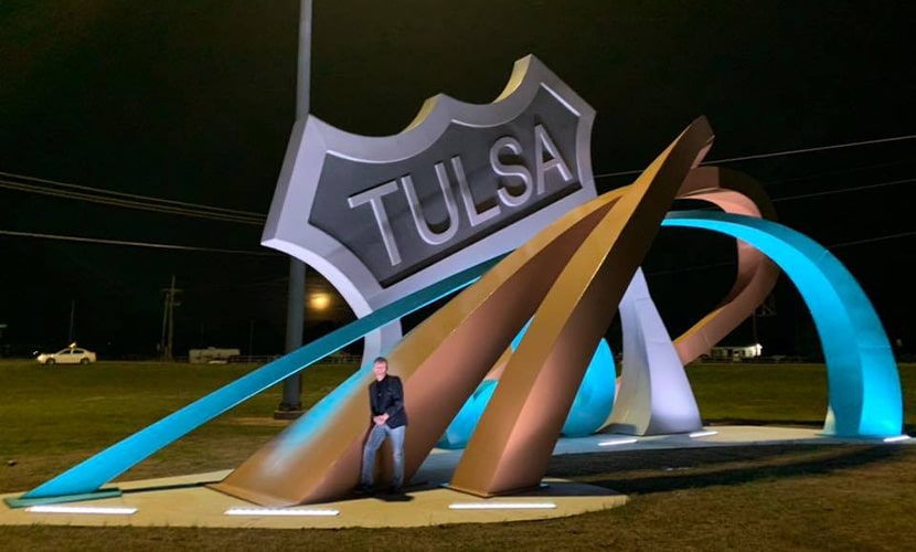 EG Structural's Eric Garcia standing in front of his Tulsa Route 66 sign
